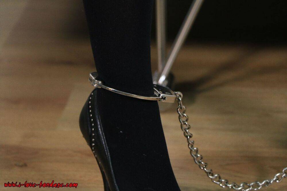 Fully clothed blonde is fastened to a wall with chains in handcuffs - #4