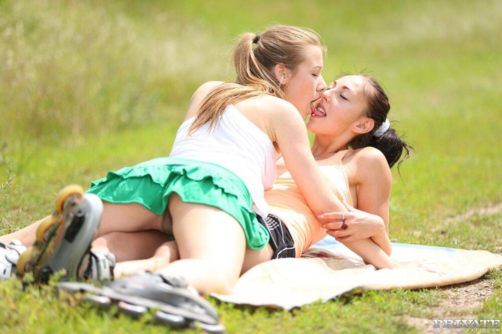 Teen lesbians El Storm and Alexis Crystal use a toy during sex in a field - #10