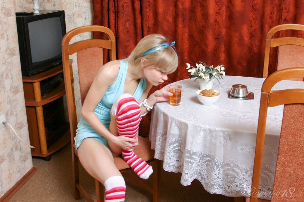 Adorable teen Cindy B gets naked on a dining room chair in striped OTK socks - #4