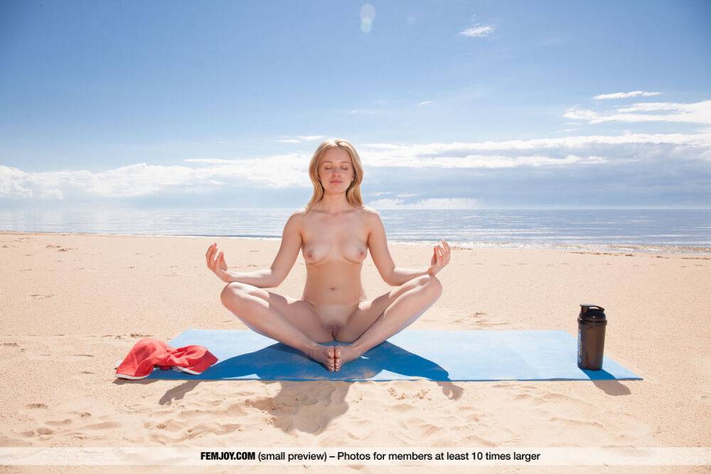 Nice teen Lee D gets totally naked during a yoga routine on the beach - #1