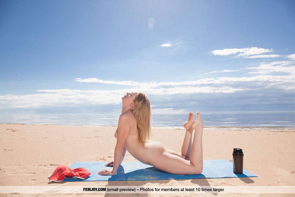 Nice teen Lee D gets totally naked during a yoga routine on the beach - #11