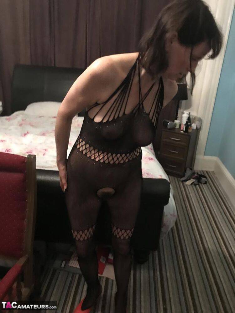 Older amateur Slut Scot Susan shows her beaver on a bed in a bodystocking - #7