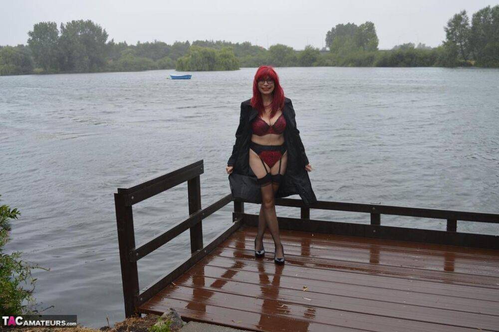 Mature redhead Barby Slut gets naked in public places on a wet day - #2