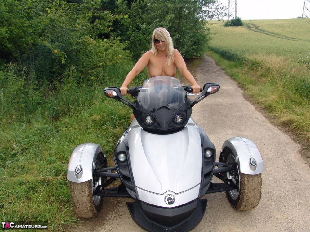 Middle-aged blonde Sweet Susi rides a three wheeled motorcycle while naked - #4