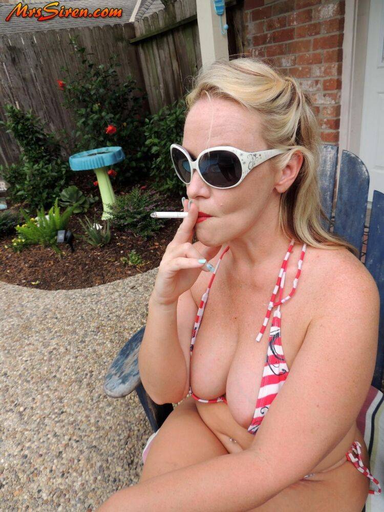 Fat blonde Dee Siren smokes while taking off a bikini in the backyard - #15