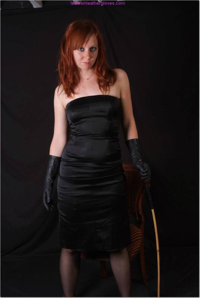 Natural redhead holds a cane with leather gloves while exposing her pink slit - #7