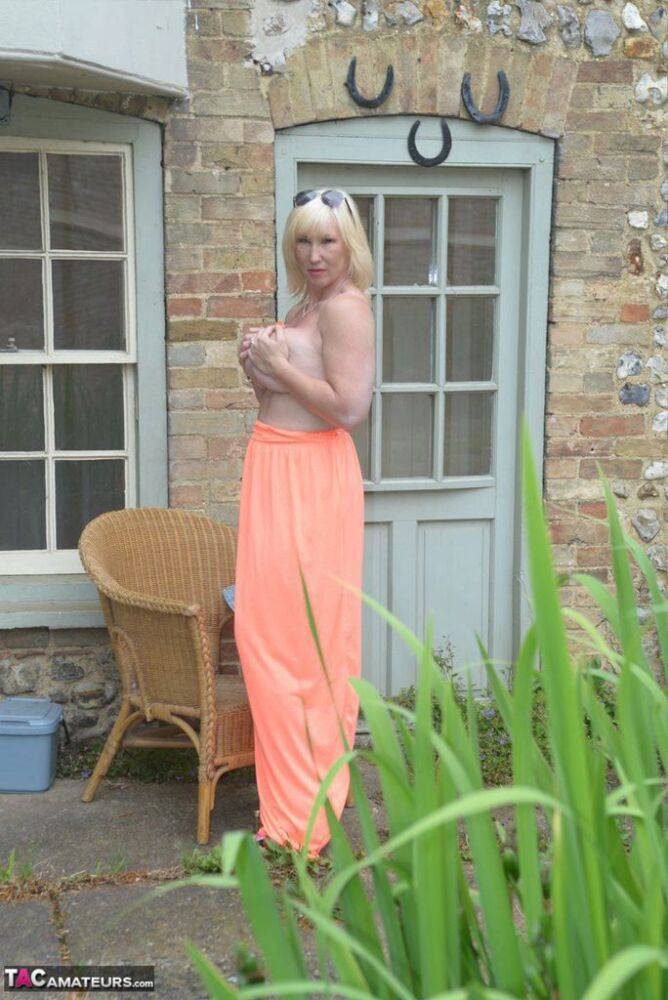 Big titted blonde Melody drops her dress outside to air her naked mature tits - #8