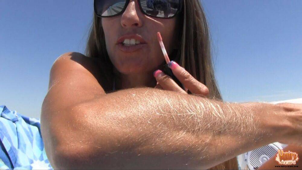 Amateur chick Lori Anderson tugs on her hairy arms in a bikini and shades - #1