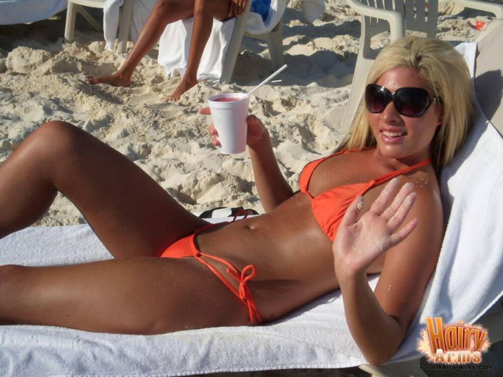 Hirsute blonde Lori Anderson relaxes on a beach in her bikini and sunglasses - #9