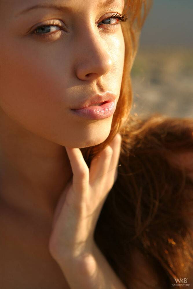 Slim teen with red hair and a pretty face models totally naked on beach sand - #2