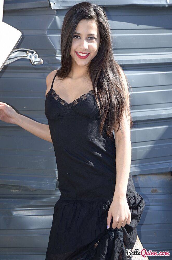 Dark haired amateur Bella Quinn models a black dress outdoors in junkyard - #5