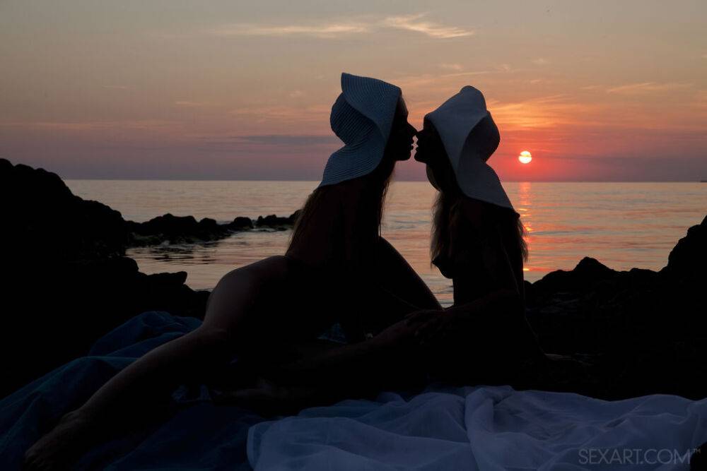 Teen lesbians Milena D & Nika N licks twats on a beach as the sun sets - #9