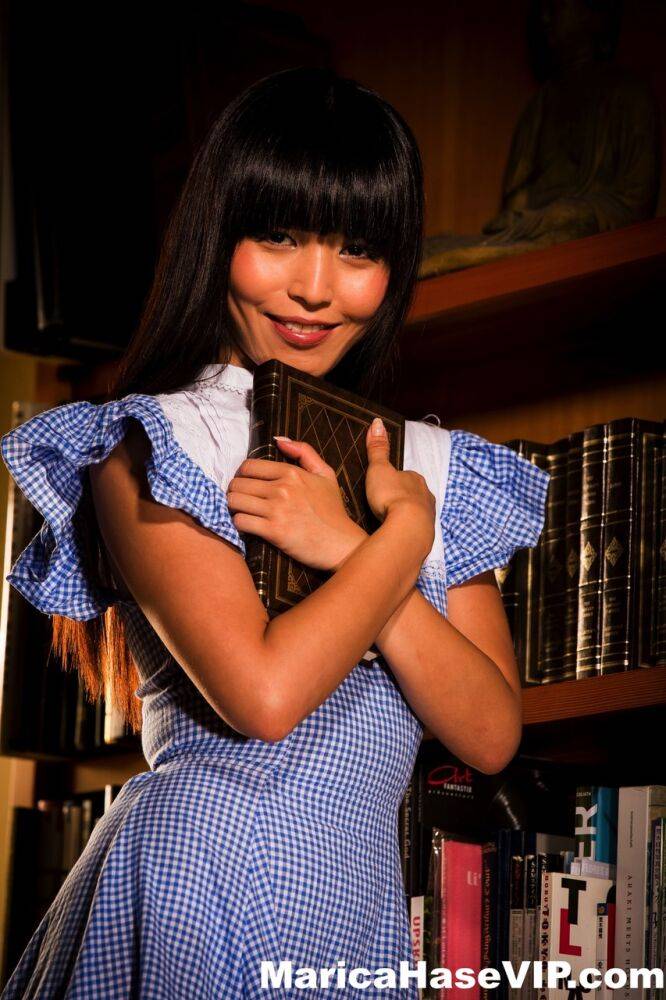 Japanese female Marica Hase flashes her panties while taking a book from stack - #4