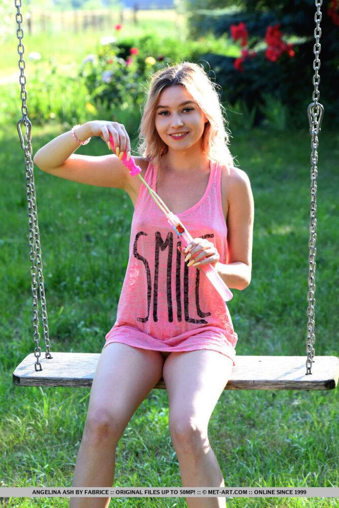 Young blonde Angelina Ash gets completely naked on a bench swing in the yard - #15