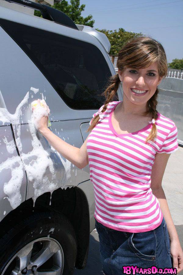 Young girl in pigtails wets her tiny tuts while washing a car in driveway - #16