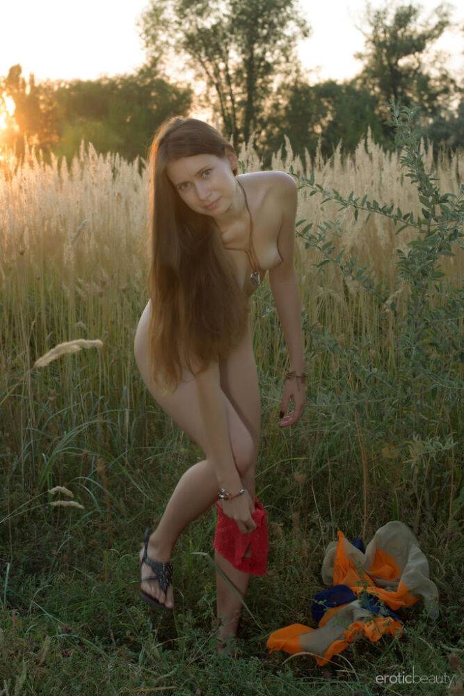 Naked teen Lady Di romps nude and spreads pussy at sunrise in a field - #13