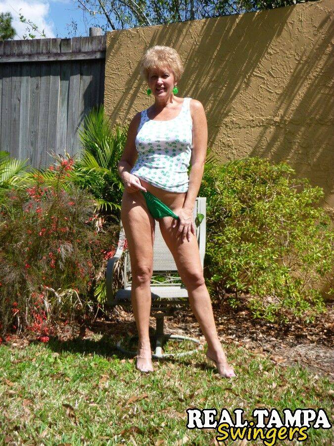 Mature lady takes off hr underwear to show her twat on a chair in backyard - #9