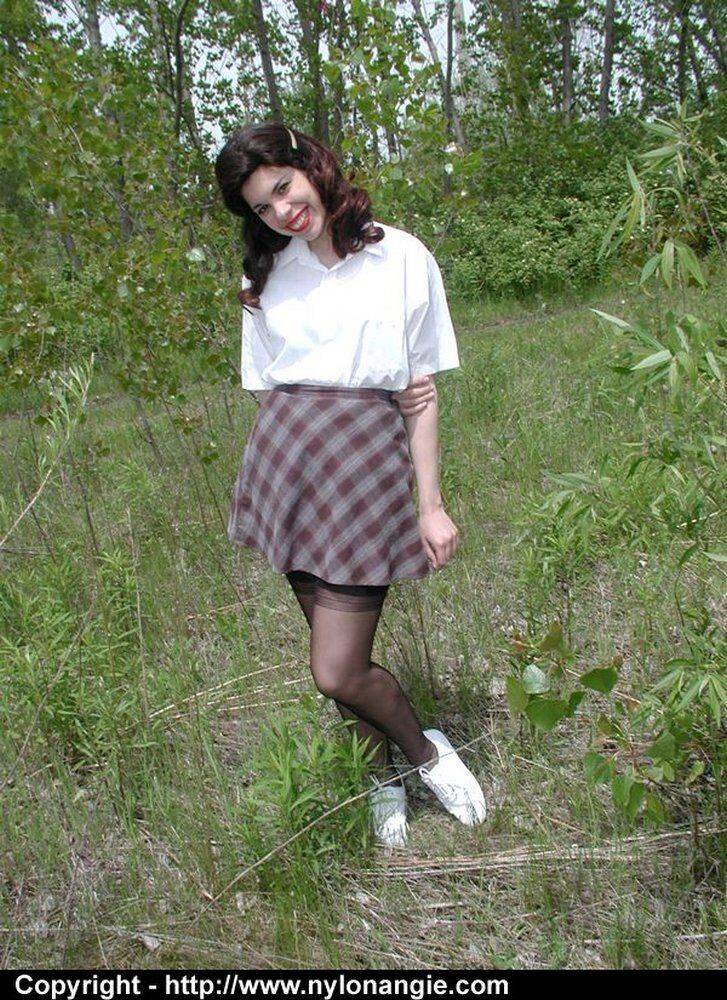 Amateur girl doffs retro clothes while wearing nylons in a field - #10