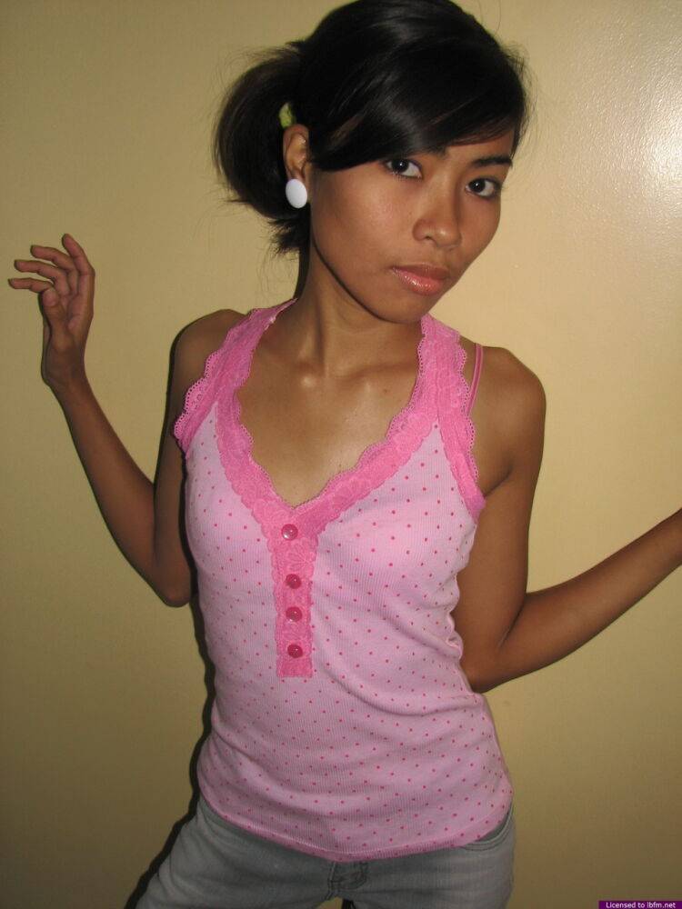 Slim 18 year old Asian girl shows her hairless pussy after a striptease - #1