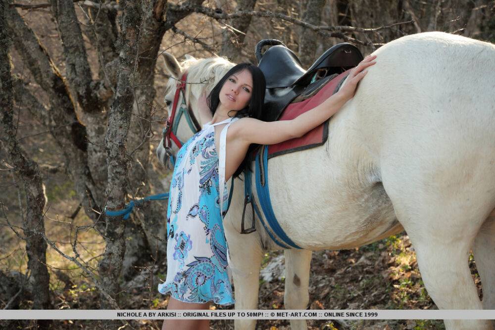 Dark haired teen Nichole A dismounts her horse in woods to pose totally naked | Photo: 2095876