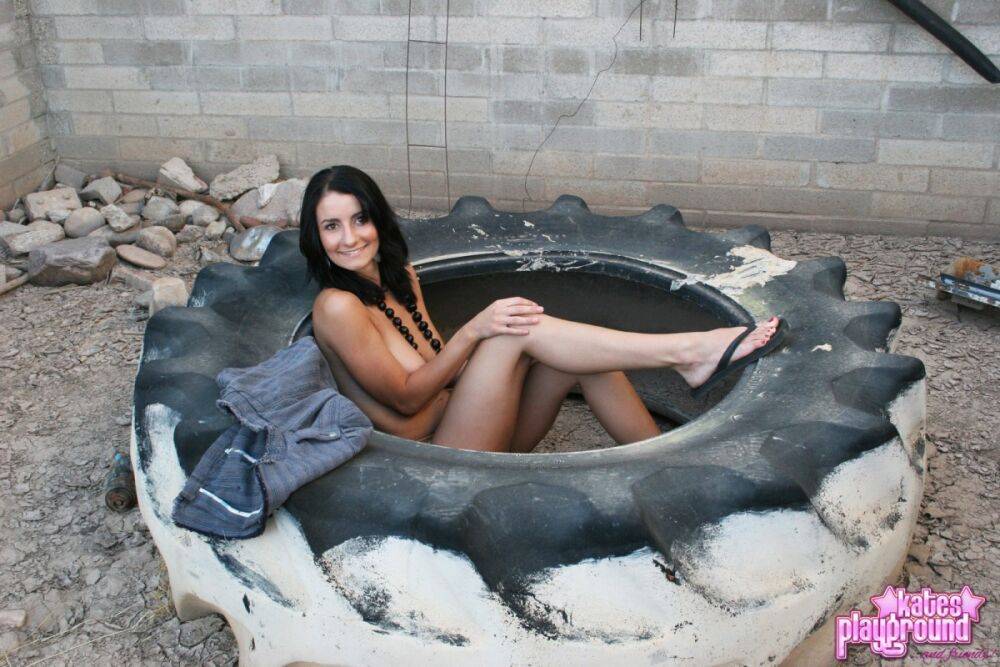 Dark-haired teen Stacy gets naked on a used tire in a safe for work manner - #2