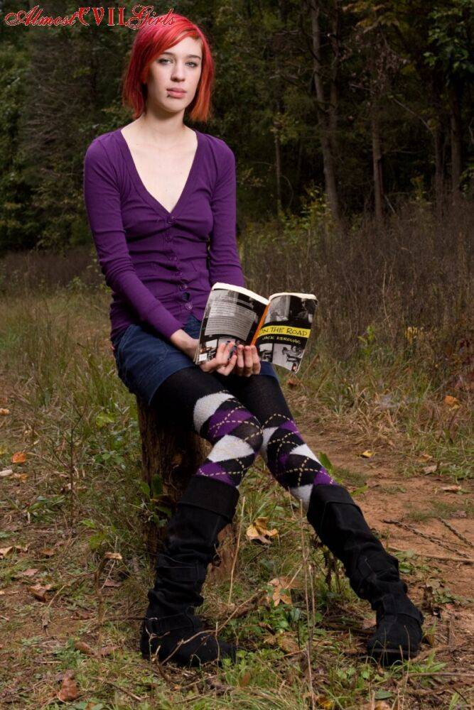 Redhead chick exposes upskirt pussy and tits while sitting on a stump - #8