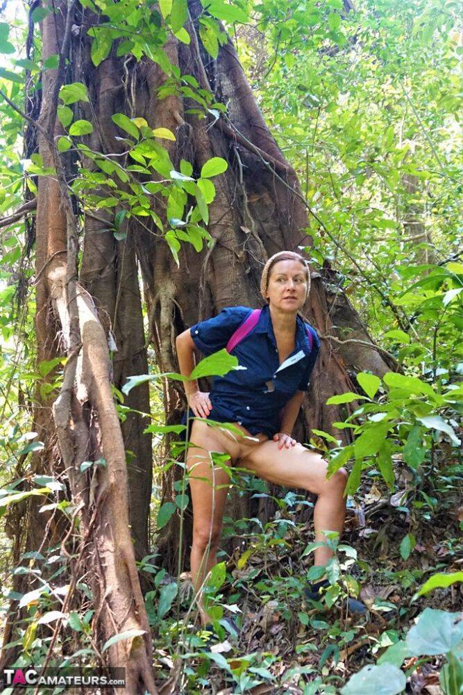 Mature amateur Diana Ananta sports a no panty upskirt while hiking in a forest - #10