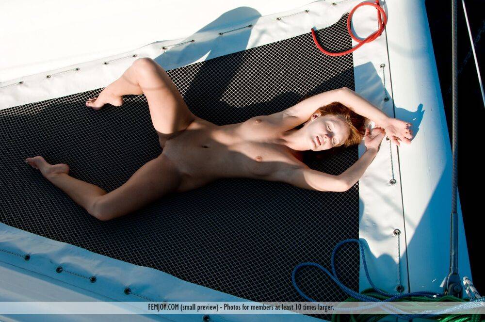 Natural redhead Denisa poses for a totally nude gig on a sailboat - #10