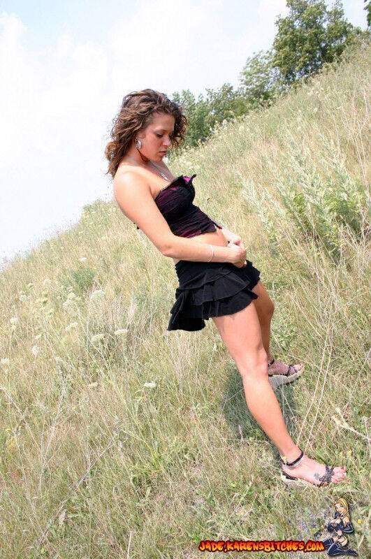 Teen amateur shows some cleavage during a SFW shoot out in a field - #10