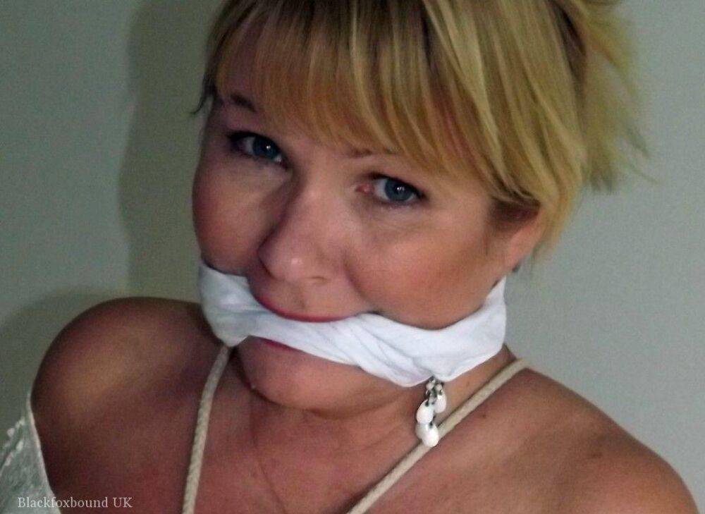 Blonde female is cleaved gagged and tied with rope in a number of dresses - #9