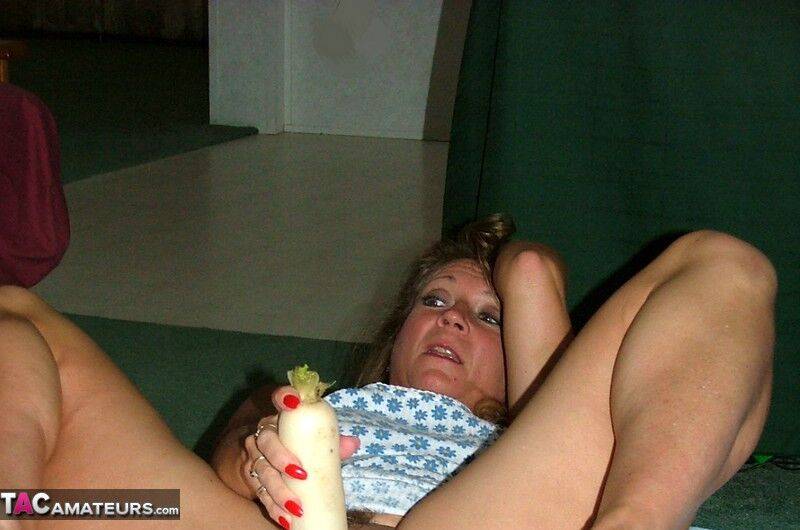 Mature amateur woman Devlynn toys her pussy with a veggie atop a sheet - #5