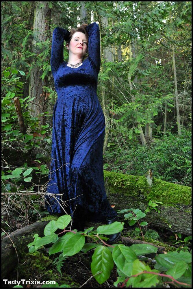 Mature woman Tasty Trixie heads into the woods to flash in a long velvet dress - #1