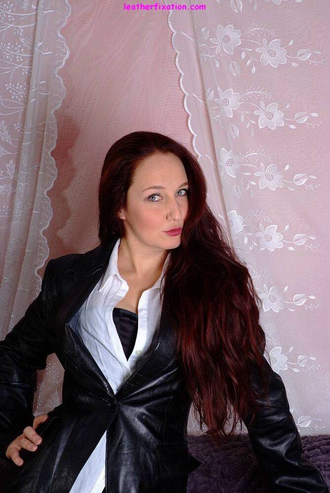 Solo model with long red hair models a leather jacket in garters and nylons - #8