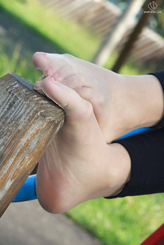 Lovely Christelle is showing her fine feet on a children playground - #8