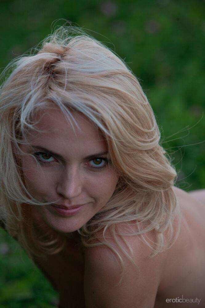 Sexy blonde teen Lilly A models naked in the grasses alongside a river - #11