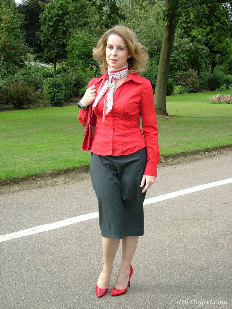 Mature woman crosses her hose covered legs in a long skirt and red pumps - #5