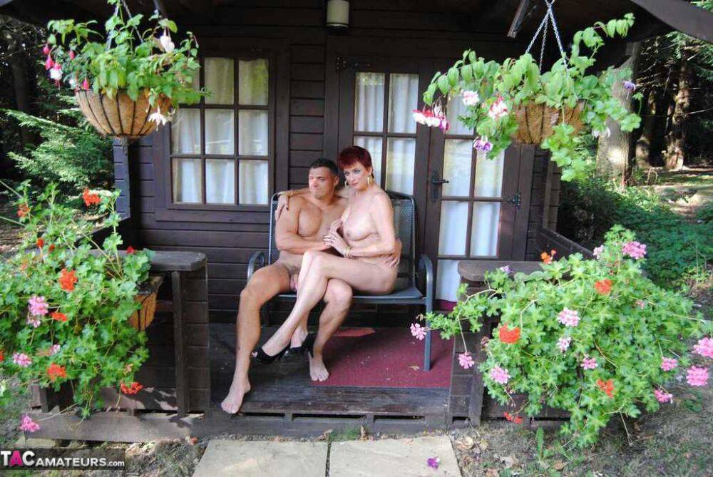 Mature redhead Dimonty gets pushed on a swing by her naked lover - #16