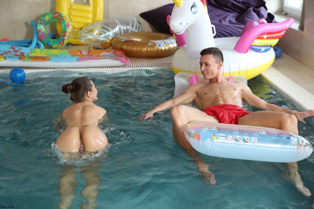 Nude beauty teases her man friend while he chills on an air mattress in a pool - #9