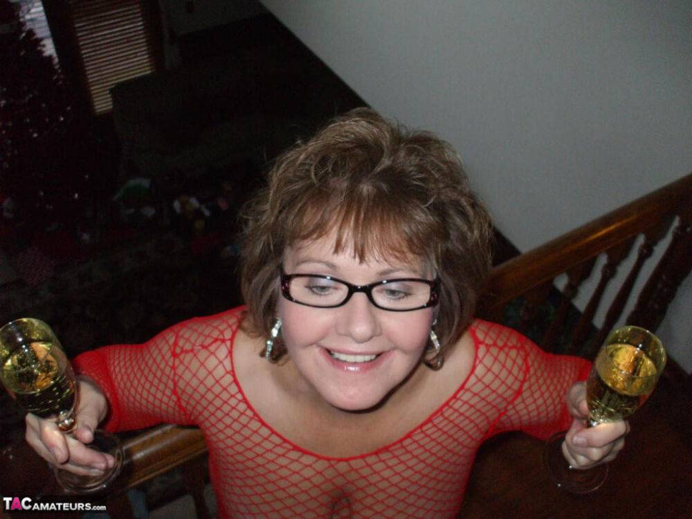 Mature lady in a fishnet dress and glasses drinks wine before stroking cock - #15