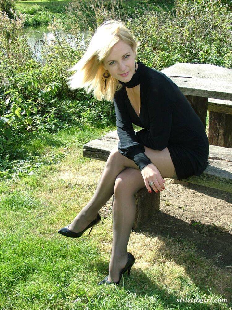 Blonde seductress models her sexy feet and long legs wearing heels in the park - #11