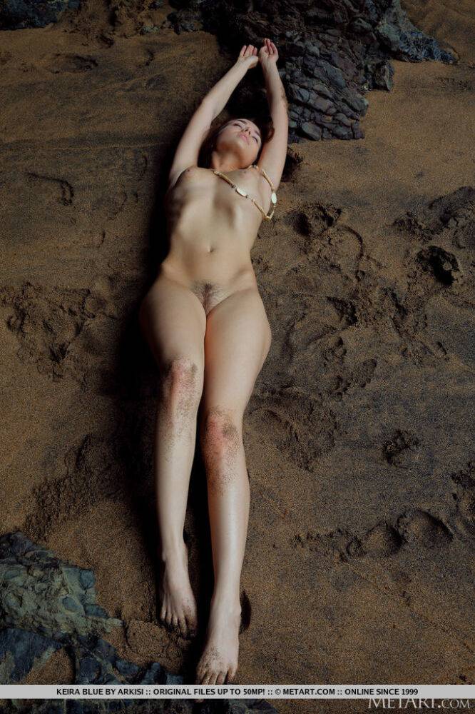 Naked teen Keira Blue models for a solo shoot on wet sand in a sea cave - #6