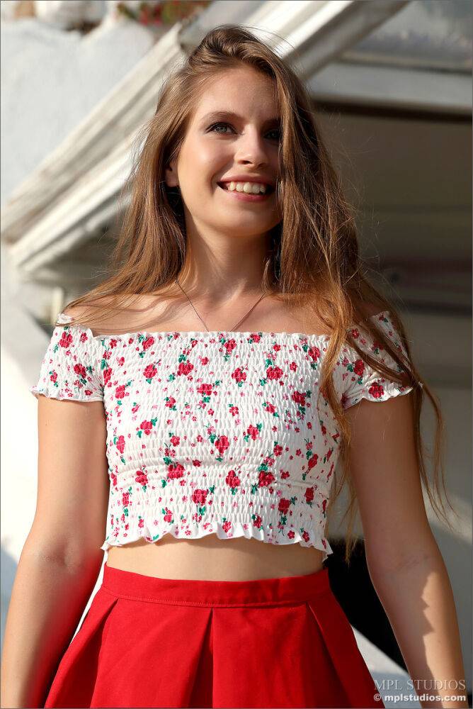 Pretty girl models fully clothed in a red skirt while on vacation - #8