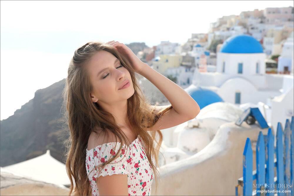 Pretty girl models fully clothed in a red skirt while on vacation | Photo: 2657316