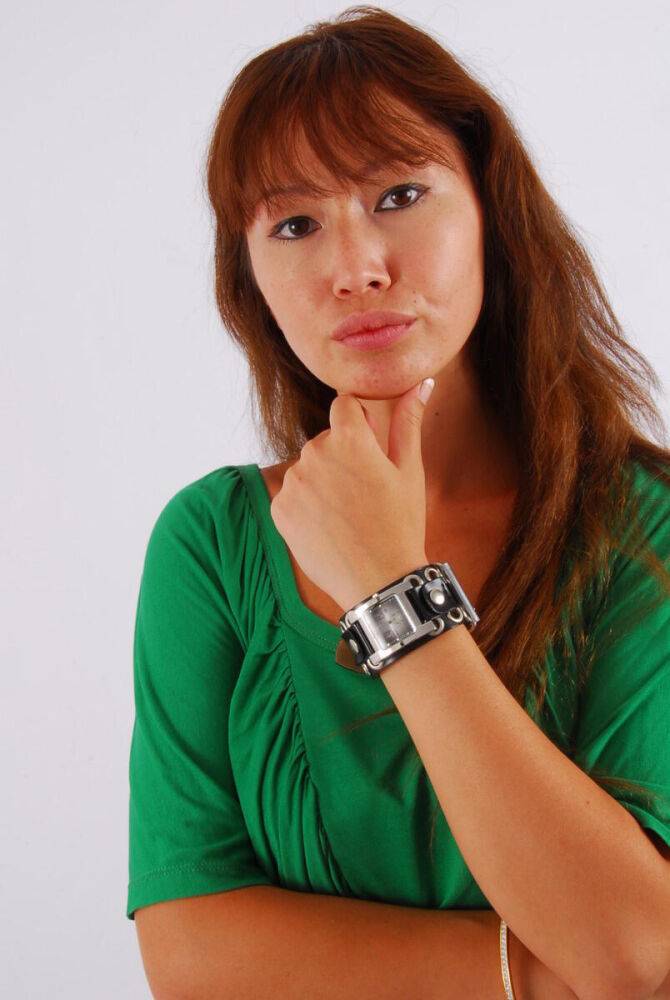 Redheaded Asian girl Evita models a Guess style cuff watch during SFW action - #10