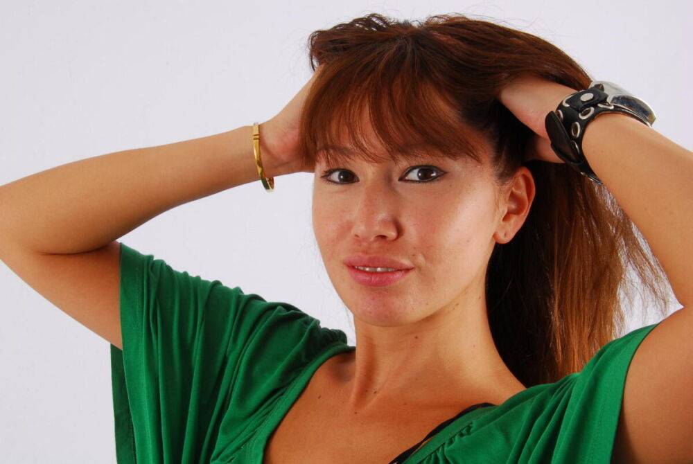 Redheaded Asian girl Evita models a Guess style cuff watch during SFW action - #11