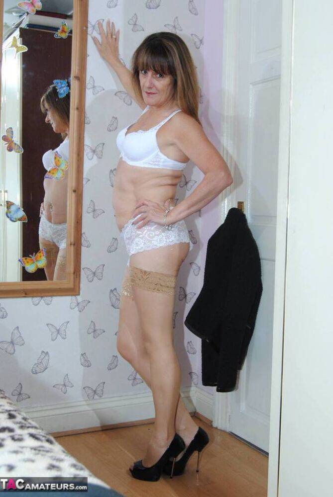 Older amateur Dimonty models in her bedroom in wearing underwear and stockings - #13