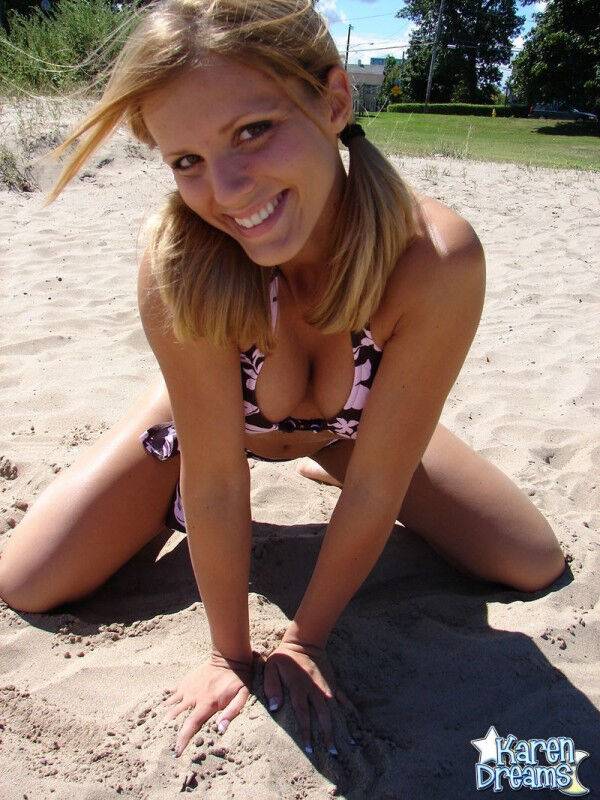 Blonde teen Karen models a bikini while on a patch of sand - #4