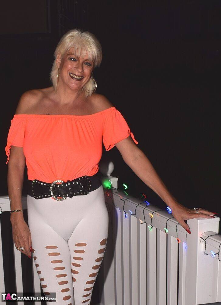 Beautiful mature wife Dimonty models big titted body in tight pants on balcony - #14