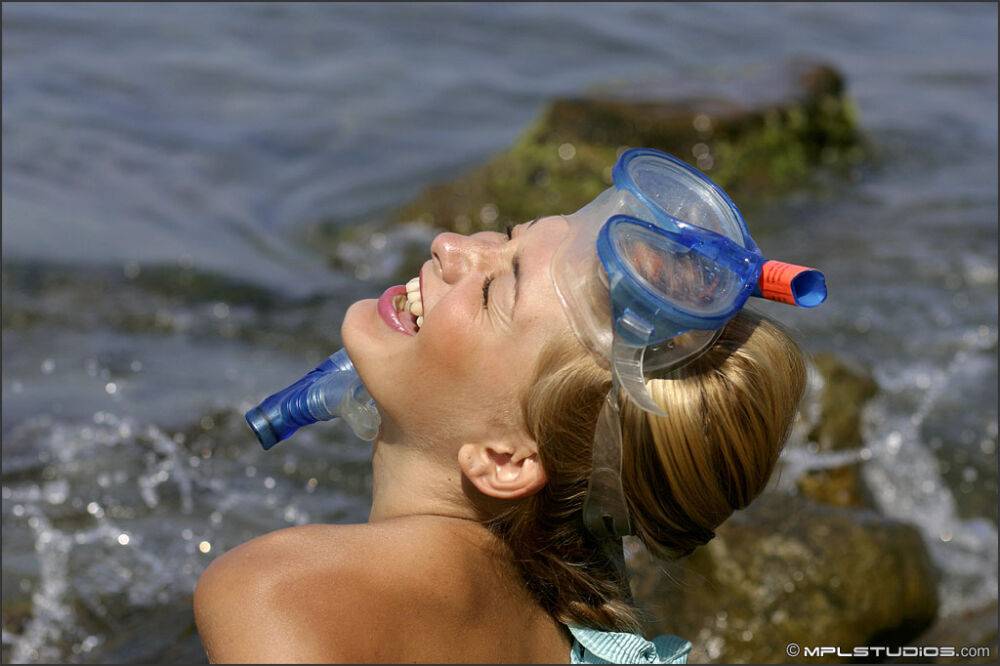 Sweet teen models naked on a rock in the ocean in snorkeling gear - #7