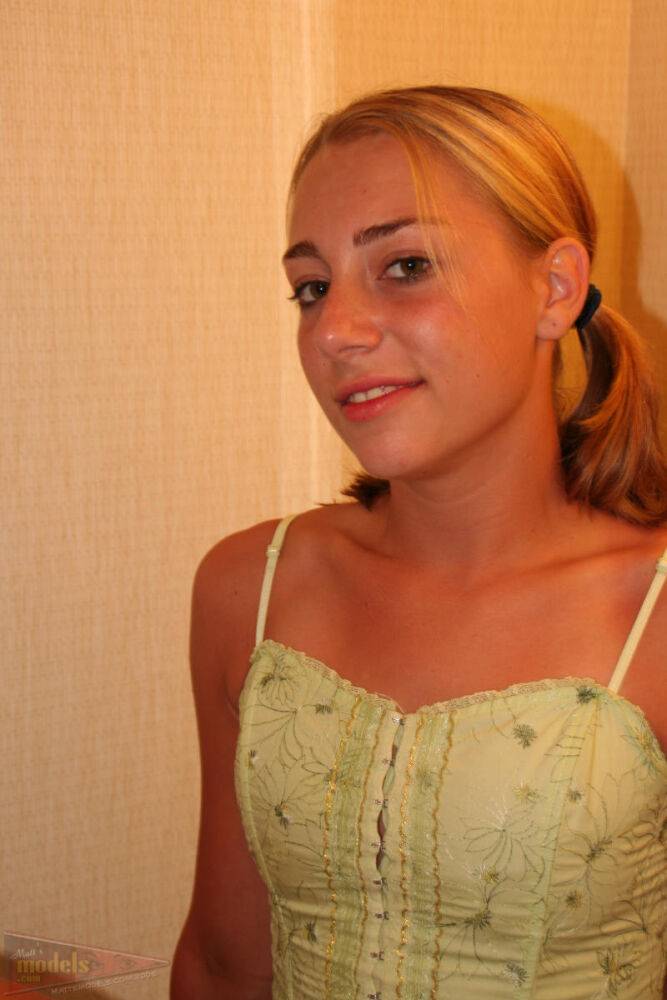 Young blonde Krista looks in a mirror after getting completely naked - #12